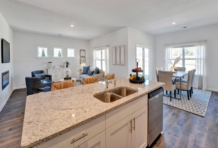Kitchen featuring white cabinetry, open floor plan, dark wood-style floors, an island with sink, and light stone counters