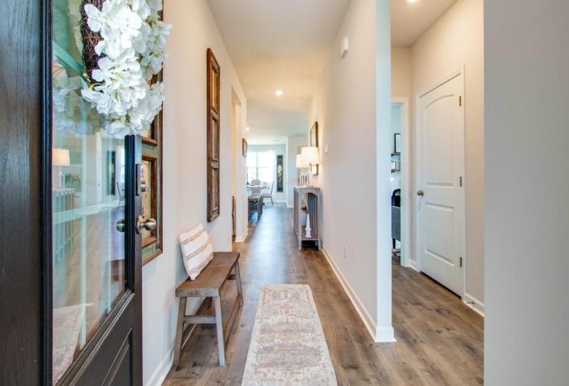 Hall featuring recessed lighting and dark wood-type flooring