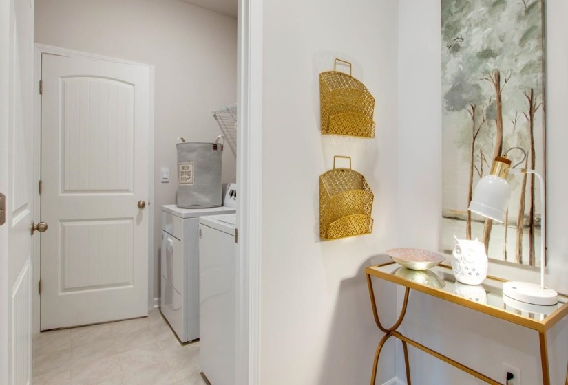 Laundry area featuring independent washer and dryer and light tile patterned floors