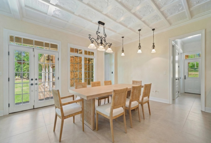 Dining area with crown molding and french doors