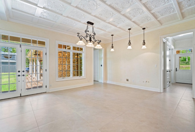 Empty room featuring crown molding and french doors