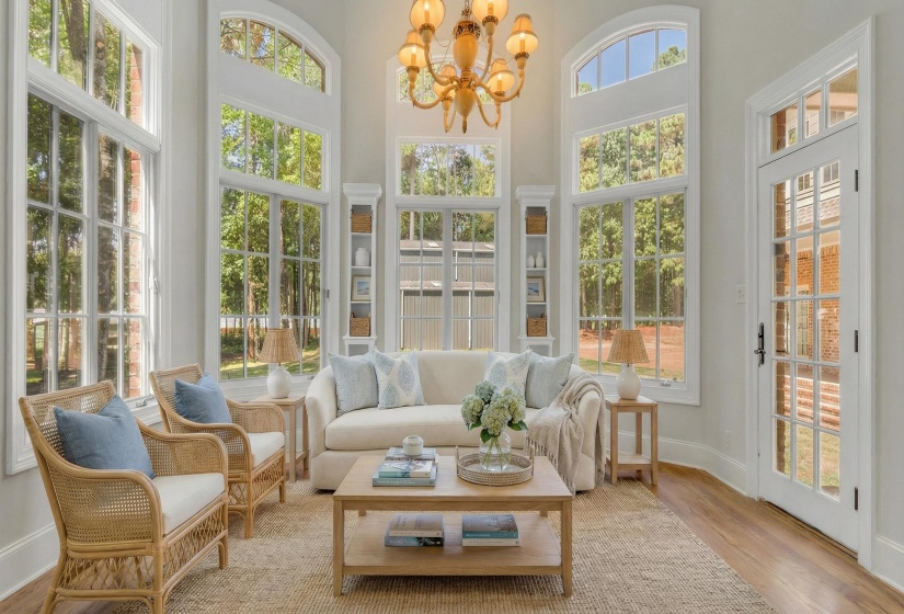 Sunroom / solarium with hanging lights and french doors