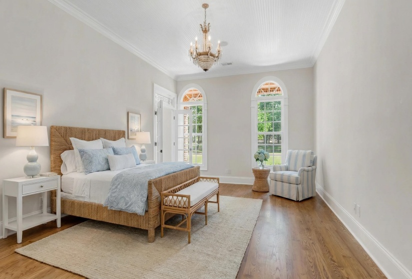 Bedroom featuring suspended lighting, light wood-style flooring, and ornamental molding
