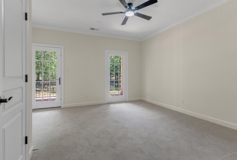 Unfurnished room featuring ornamental molding, light carpet, and ceiling fan