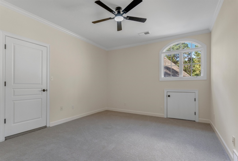 Unfurnished room with ornamental molding, light colored carpet, and a ceiling fan