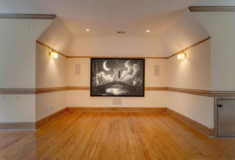 Cinema with light wood finished floors and recessed lighting