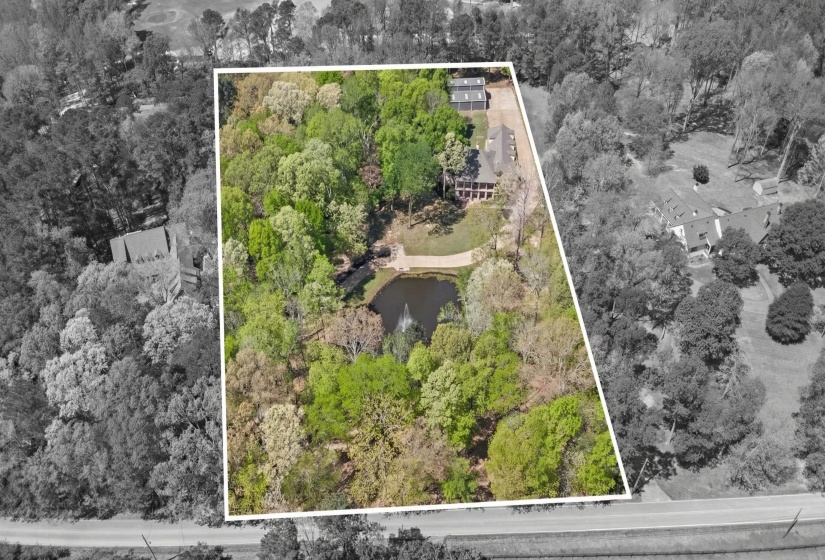Aerial view of property's location with property parcel outlined and a large body of water
