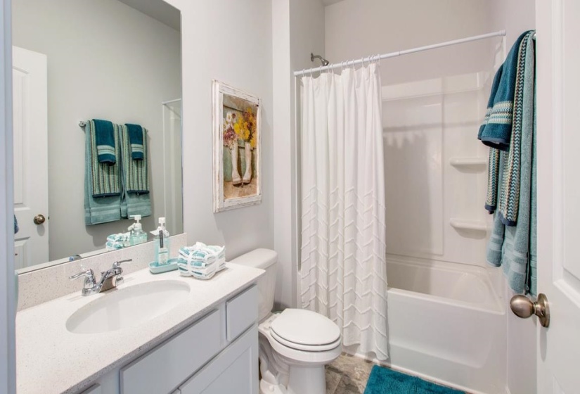 Bathroom with shower / tub combo and vanity