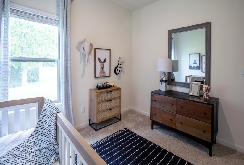 Bedroom featuring light colored carpet and baseboards