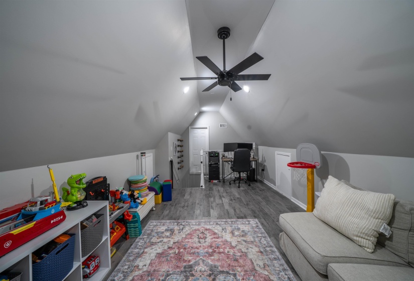 Office with lofted ceiling and wood finished floors