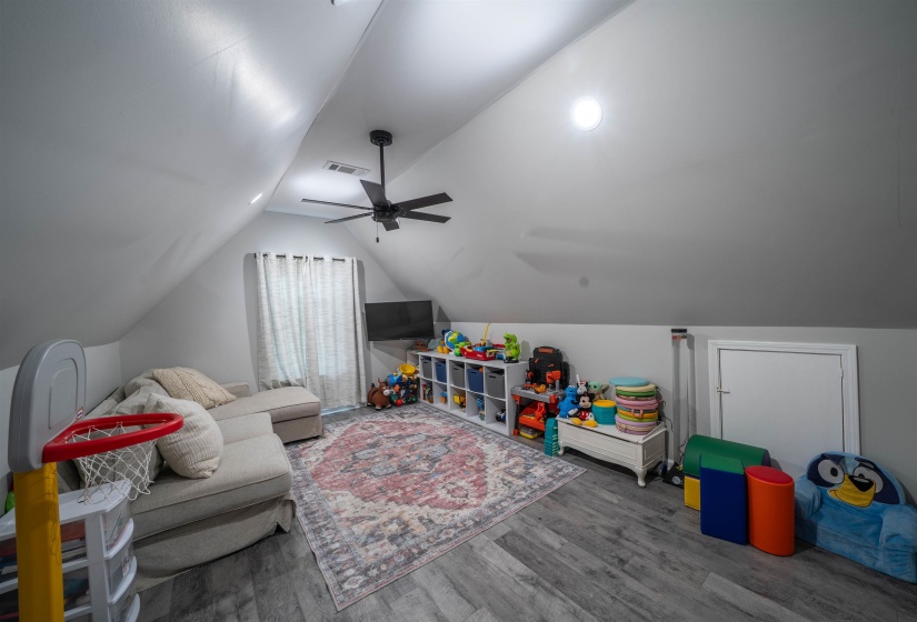 Game room featuring lofted ceiling, wood finished floors, and ceiling fan