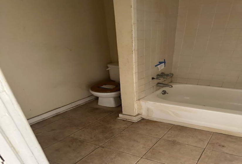 Full bath featuring light tile patterned floors and shower / tub combination