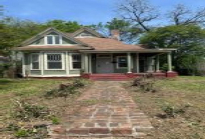 Bungalow-style house featuring a porch and a chimney