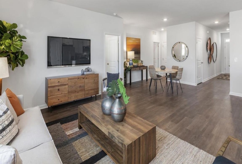 Living room with recessed lighting, baseboards, and dark wood-style floors