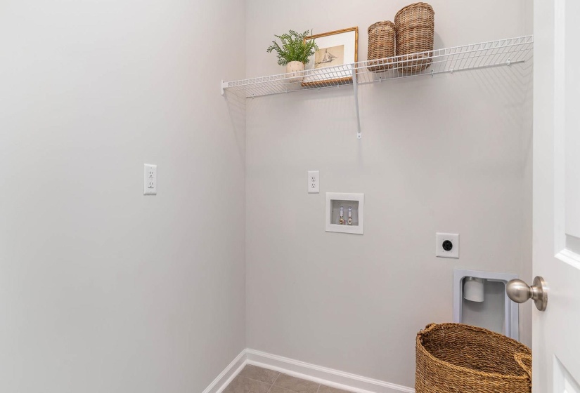 Laundry area with washer hookup, light tile patterned floors, and hookup for an electric dryer