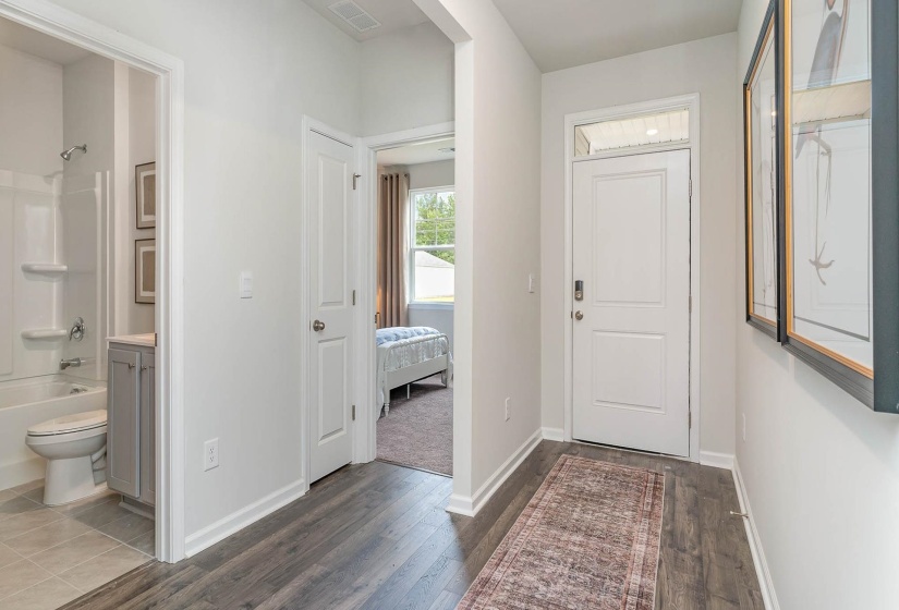 Entryway featuring baseboards and dark wood finished floors