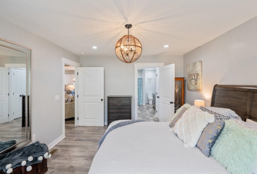 Bedroom featuring suspended lighting and light wood-type flooring
