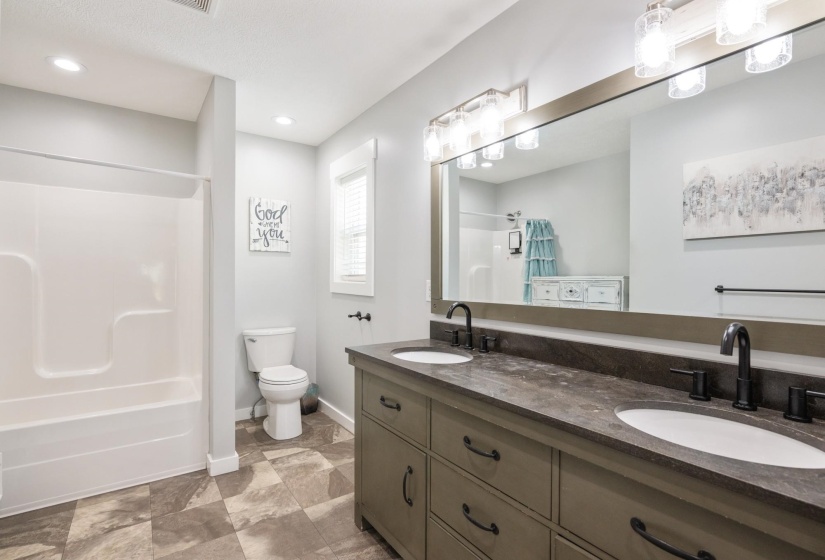 Full bath with double vanity and washtub / shower combination