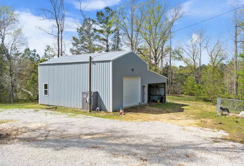 View of outbuilding featuring driveway