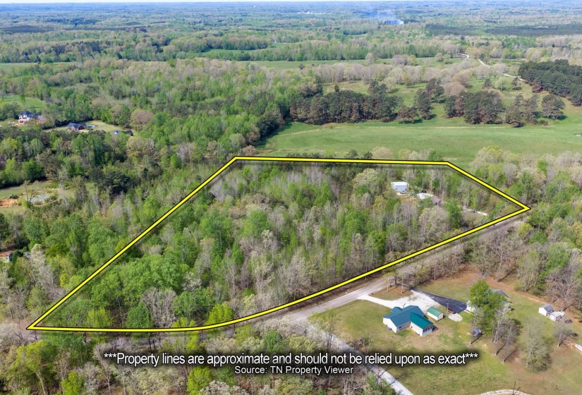 Aerial overview of property's location featuring property parcel outlined and a forest