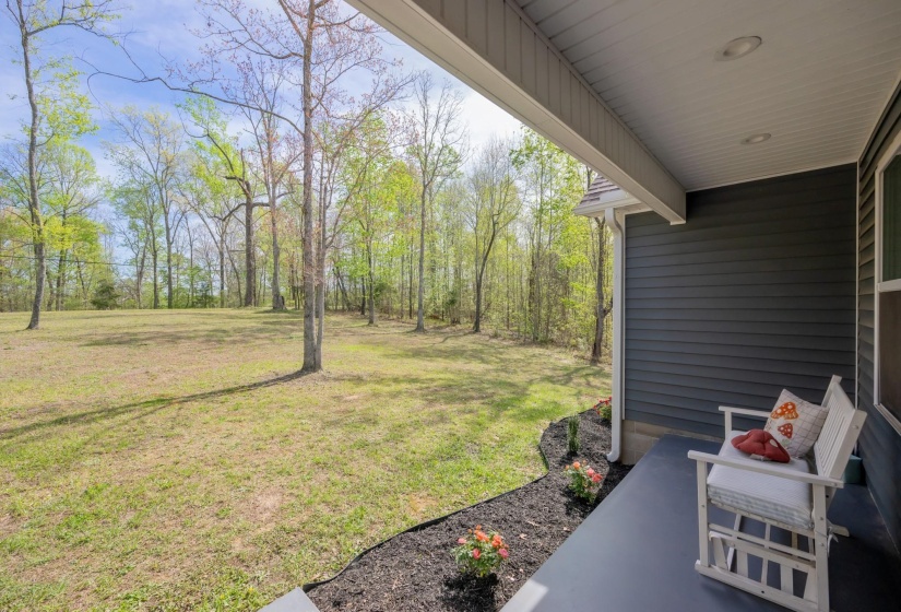 View of green lawn with a patio area
