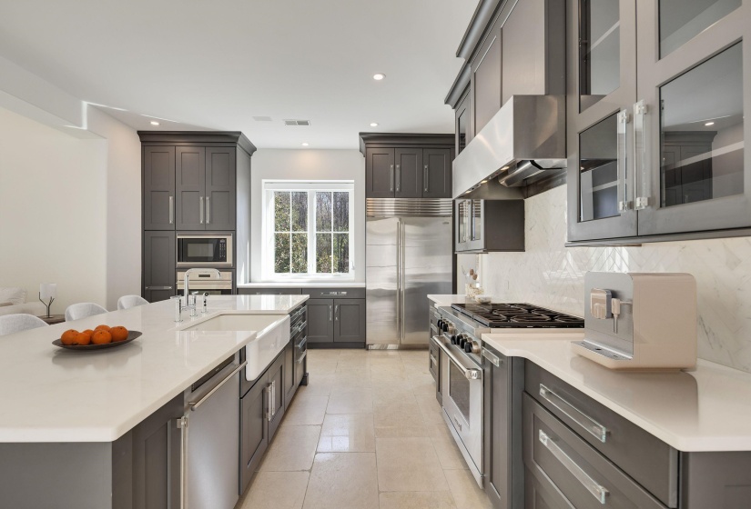 Kitchen featuring built in appliances, glass fronted cabinets, light stone countertops, recessed lighting, and decorative backsplash