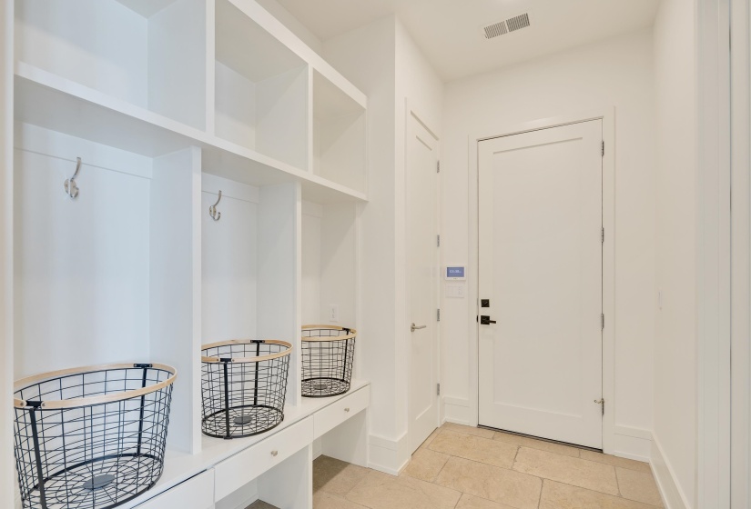 Mudroom featuring light tile patterned floors and baseboards