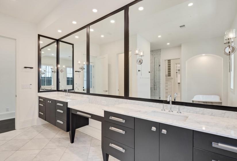 Bathroom with two vanities, a stall shower, and recessed lighting