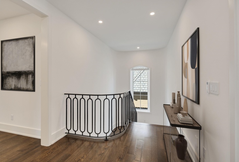 Hall featuring dark wood-style flooring, recessed lighting, and an upstairs landing