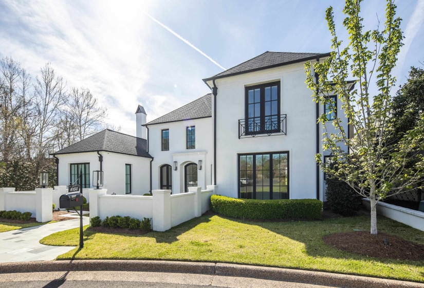 View of front facade featuring a fenced front yard, stucco siding, and a shingled roof