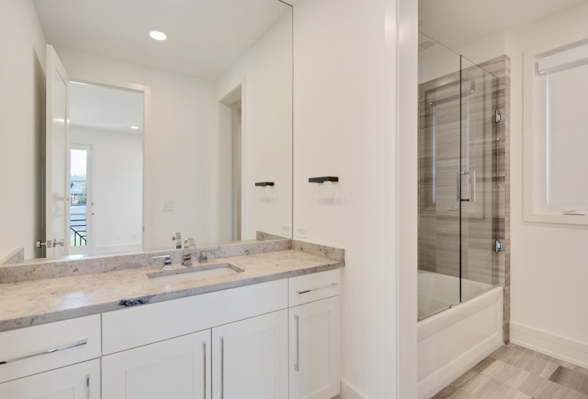 Full bathroom featuring vanity, shower / bath combination with glass door, and recessed lighting