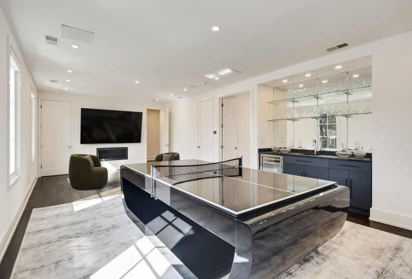 Rec room featuring dark wood-style floors, recessed lighting, bar with sink, and wine cooler