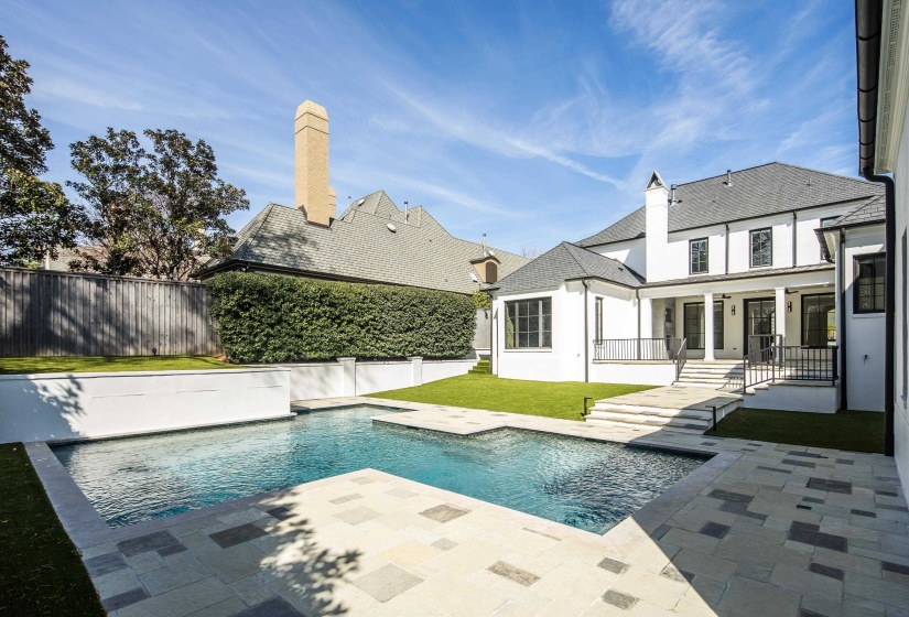 Back of property featuring a patio area, a fenced backyard, a chimney, and stucco siding