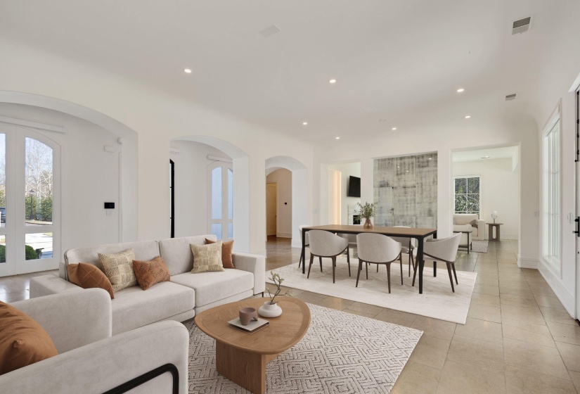 Living area featuring recessed lighting, arched walkways, french doors, and light tile patterned floors