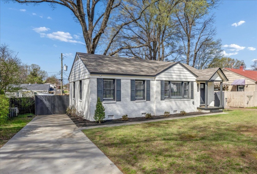 View of front of house with brick siding, roof with shingles, and concrete driveway