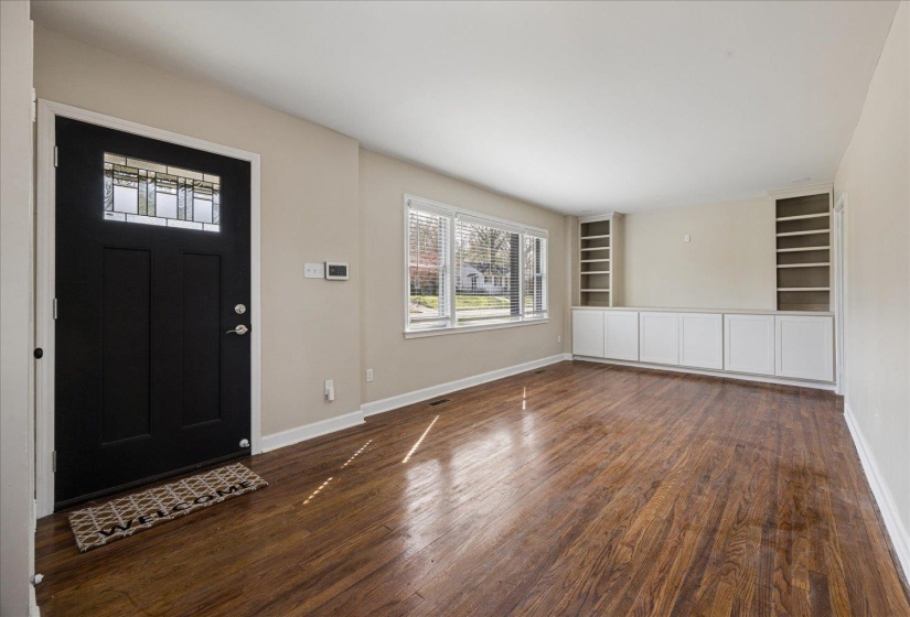 Foyer entrance featuring dark wood-style floors and baseboards