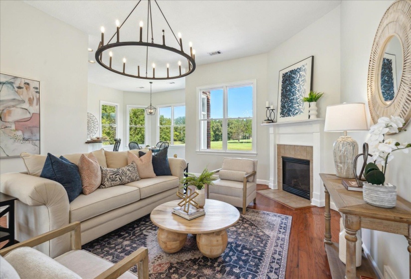 Living room with dark wood-type flooring and a fireplace