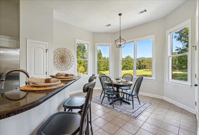 Tiled dining room with a chandelier and sink