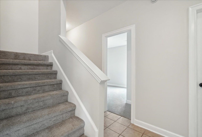 Stairs featuring light tile patterned floors