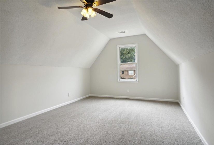 Bonus room featuring vaulted ceiling, a textured ceiling, ceiling fan, and carpet flooring