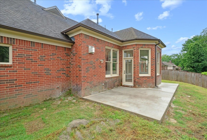 Rear view of house featuring a patio and a lawn