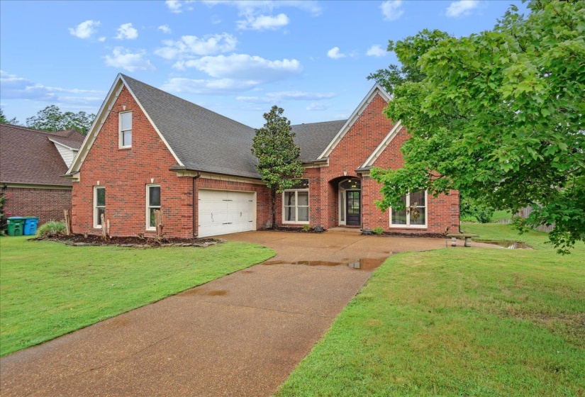 View of front of home with a garage and a front lawn