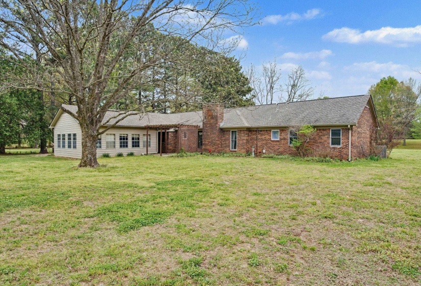 Ranch-style home featuring a front lawn and brick siding
