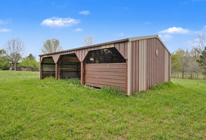 View of pole building with a lawn