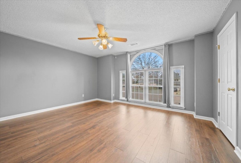 Spare room featuring a textured ceiling, a ceiling fan, and wood finished floors