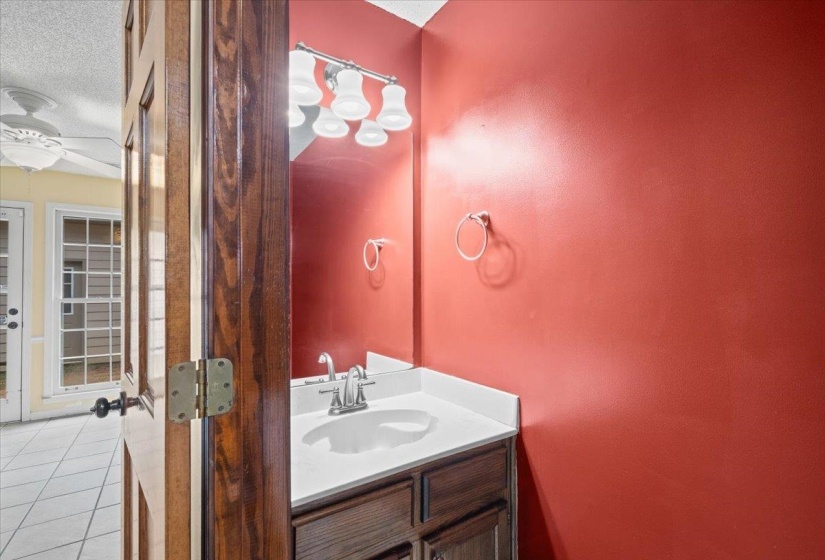 Bathroom featuring vanity, light tile patterned flooring, a textured ceiling, and ceiling fan