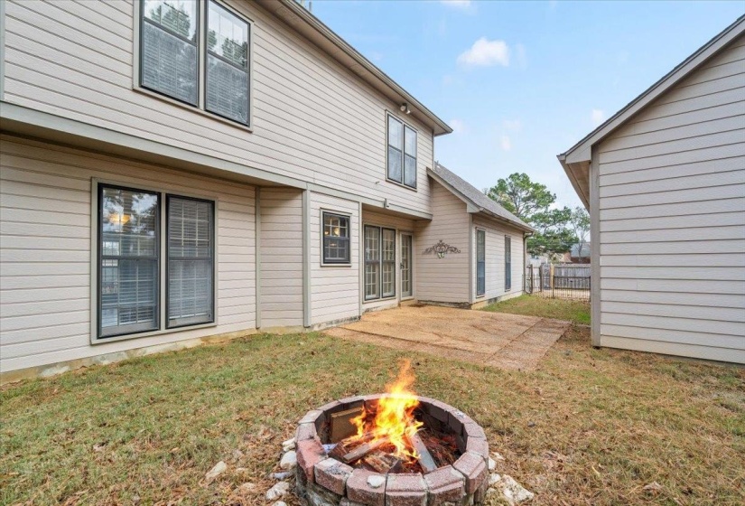 Back of property featuring a patio area and a fire pit