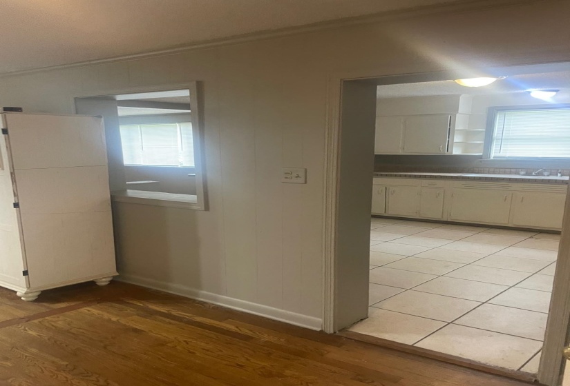 Kitchen featuring crown molding, light wood-style flooring, and open shelves