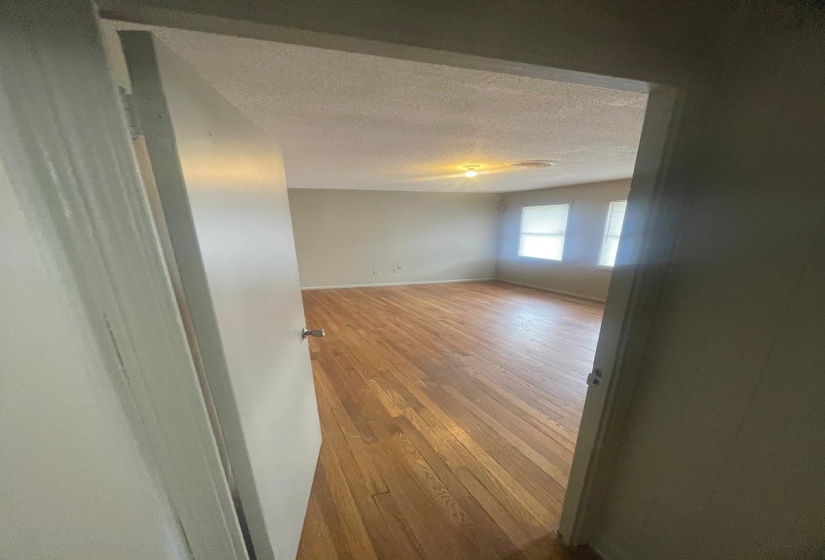 Unfurnished room featuring light wood finished floors and a textured ceiling