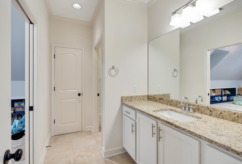 Ensuite bathroom with crown molding, vanity, recessed lighting, and light tile patterned floors